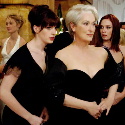 Andy (Anne Hathaway, left) whispers some important information to her boss, fashion magazine editor Miranda Priestly (Meryl Streep), as Miranda's first assistant, Emily (Emily Blunt) looks on.PHOTOGRAPHS TO BE USED SOLELY FOR ADVERTISING, PROMOTION, PUBLICITY OR REVIEWS OF THIS SPECIFIC MOTION PICTURE AND TO REMAIN THE PROPERTY OF THE STUDIO. NOT FOR SALE OR REDISTRIBUTION.