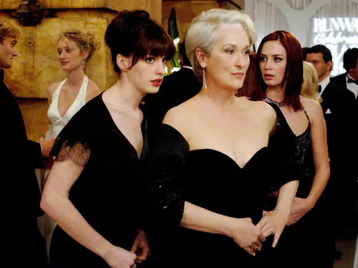 Andy (Anne Hathaway, left) whispers some important information to her boss, fashion magazine editor Miranda Priestly (Meryl Streep), as Miranda's first assistant, Emily (Emily Blunt) looks on.PHOTOGRAPHS TO BE USED SOLELY FOR ADVERTISING, PROMOTION, PUBLICITY OR REVIEWS OF THIS SPECIFIC MOTION PICTURE AND TO REMAIN THE PROPERTY OF THE STUDIO. NOT FOR SALE OR REDISTRIBUTION.
