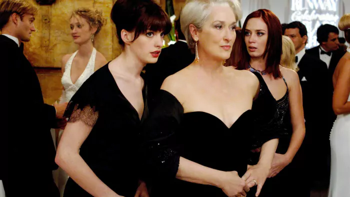 Andy (Anne Hathaway, left) whispers some important information to her boss, fashion magazine editor Miranda Priestly (Meryl Streep), as Miranda's first assistant, Emily (Emily Blunt) looks on.PHOTOGRAPHS TO BE USED SOLELY FOR ADVERTISING, PROMOTION, PUBLICITY OR REVIEWS OF THIS SPECIFIC MOTION PICTURE AND TO REMAIN THE PROPERTY OF THE STUDIO. NOT FOR SALE OR REDISTRIBUTION.