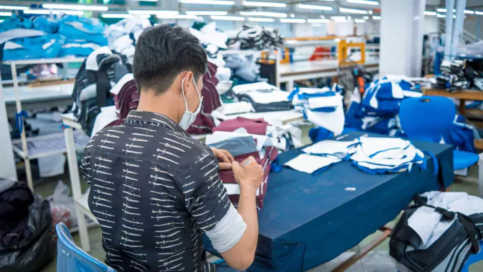 two-asian-man-wearing-medical-mask-writing-number-fabric-after-finished-cut-textile-cloth-factory-working-process-tailoring-workers-equipment